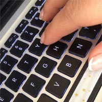 Fingers on a laptop keyboard